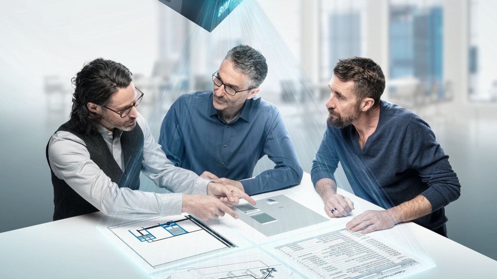 Инженеры-проектировщики увлеченно обсуждают проект за столом с символом BIM Инженеры-проектировщики увлеченно обсуждают проект за столом с символом BIM